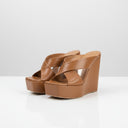 Jolie Jordan Boutique Vicini cognac leather crossover strap platform wedge mules with square toe.